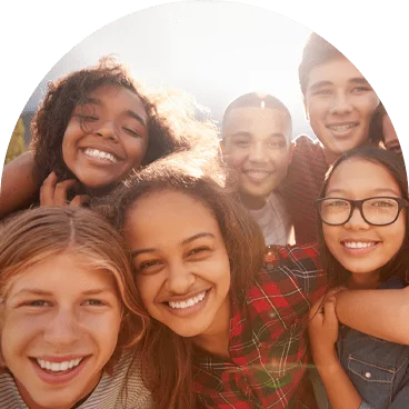 a group shot of kids smiling at the camera