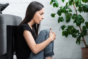 woman crouched down having a panic attack